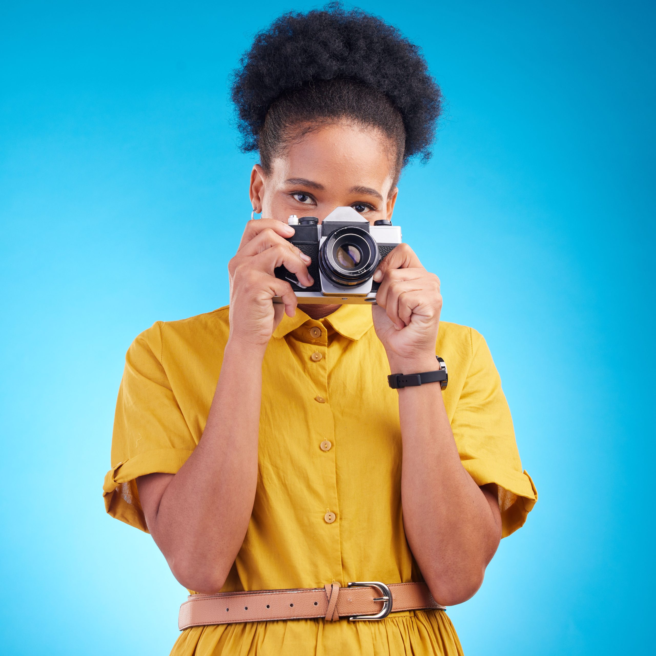 Photography, portrait and black woman with camera isolated on blue background, creative artist job .